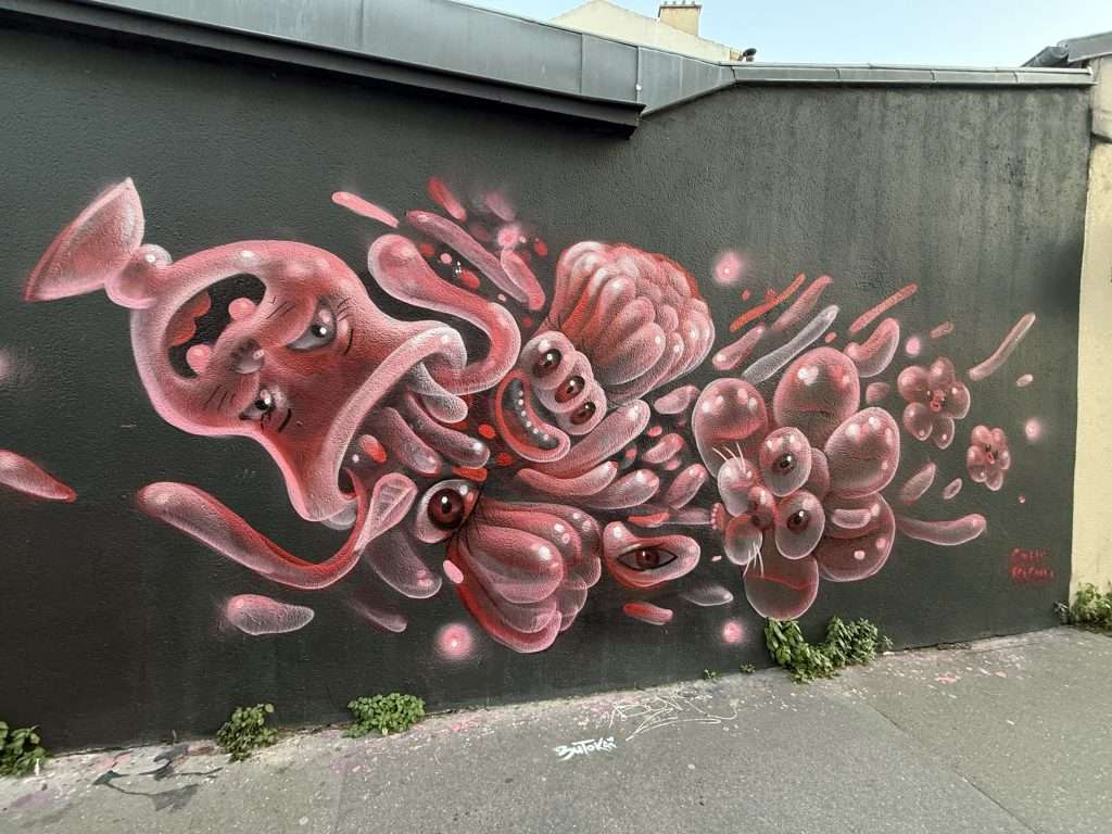 Pink Cup Spilling Balloons with Faces Street Art In Paris