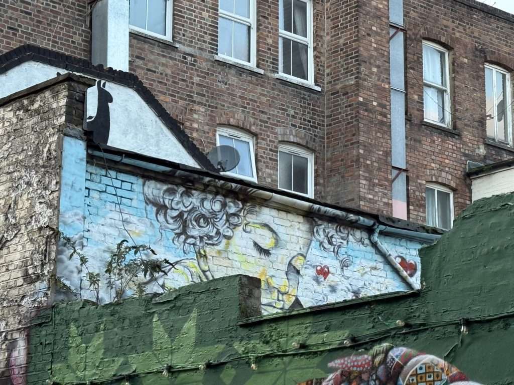 Street Art England Cherub on Brick Building