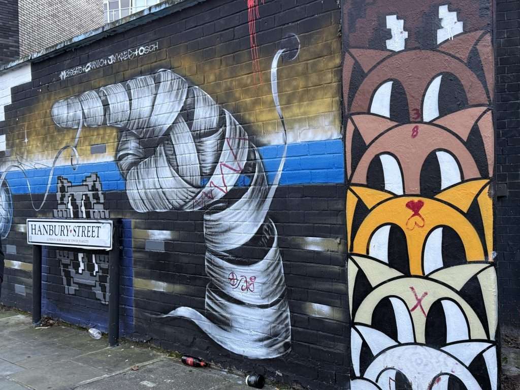 Hanbury Street Street Art In London England Cats and a Pointing Mummy Finger