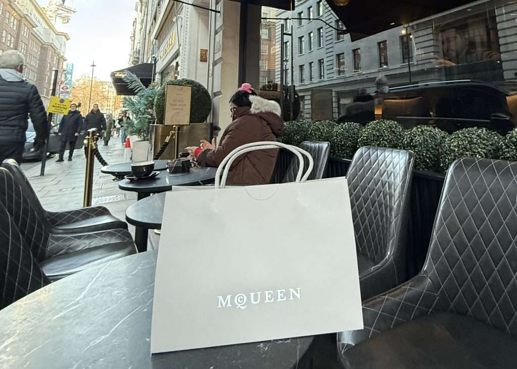 Alexander McQueen Bag on a Cafe Table In London Best Shopping Streets In London